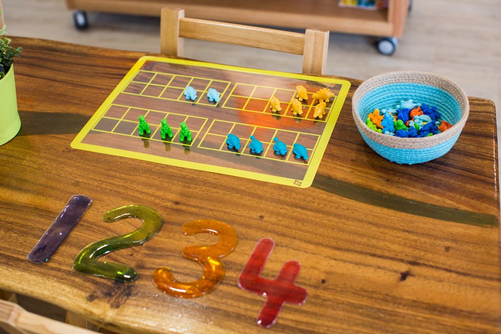 Column image Children participating in literacy and numeracy learning activities at a Kids Club childcare centre