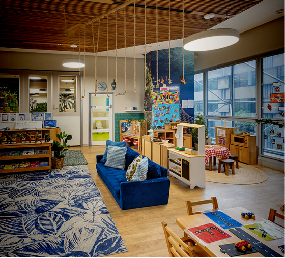 Column image Early childhood centre play and reading area with sofa, rope feature, and educational displays