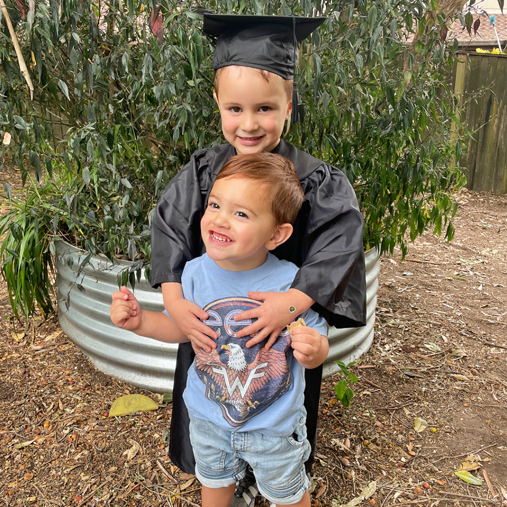 Supporting Your Child's Transition to School - Kaiden on his Graduation Day with his little brother, Zade.