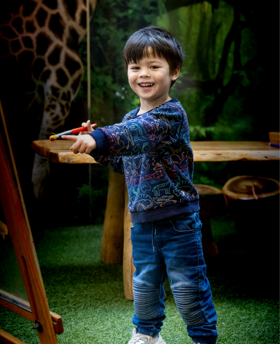 Column image Child drawing on board during creative play at childcare centre