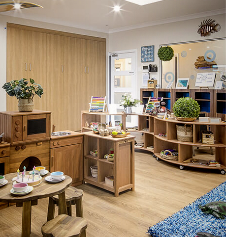 Column image Childcare ocean room with wooden learning furniture, toys and organised play stations