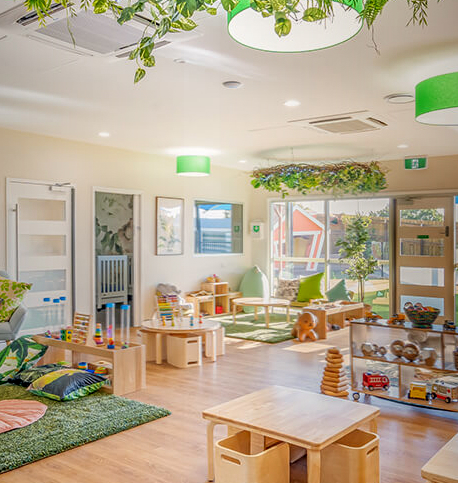 Column image Childcare rainforest room with natural play area, wooden toys, greenery and soft learning spaces