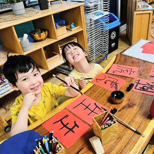 Column image Children participating in a language extracurricular activity at Kids Club childcare centre while learning cultural communication and creative expression skills.