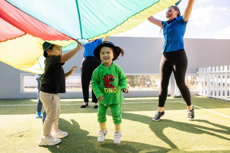 Carousel image Children and educators participating in active outdoor play at Kids Club Childcare Centre, supporting physical health, safety and wellbeing through engaging group activities.