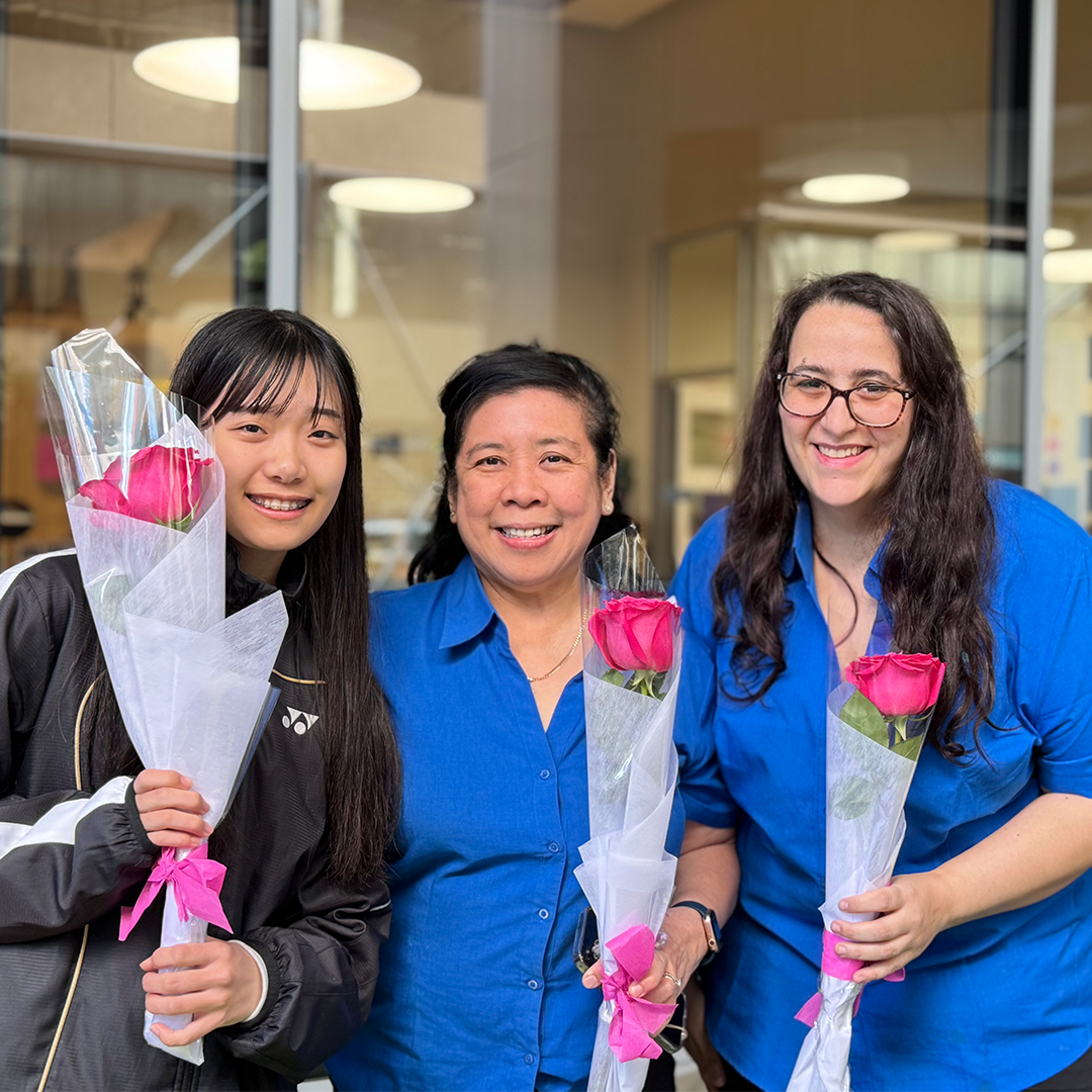 Column image Kids Club Childcare Centre educators celebrating together with flowers during a special appreciation event.