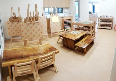 Column image Creative visual arts learning space inside a Kids Club childcare centre with easels and activity tables