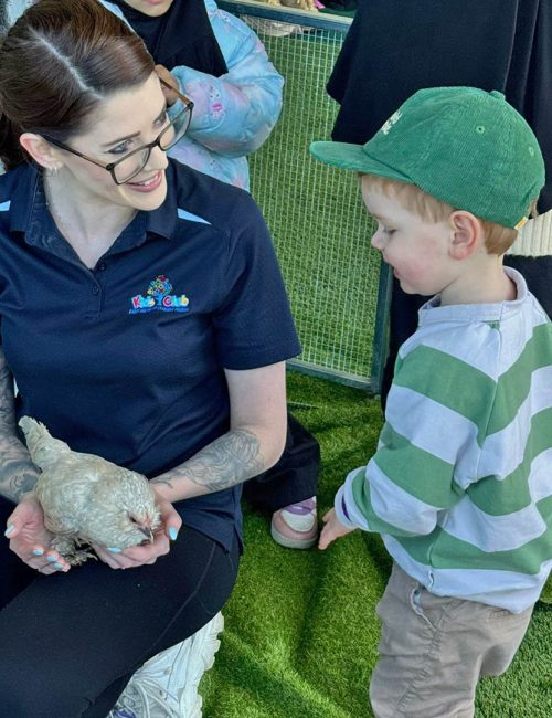 Educator and child enjoying the petting zoo at Kids Club Paddington Family Fun Day